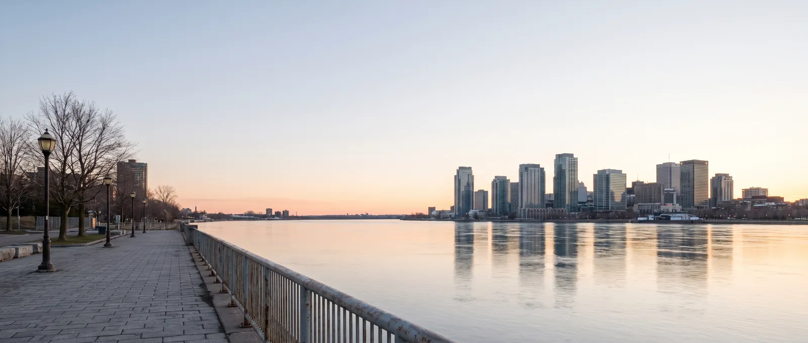 Dawn over the river and a skyline from a promenade