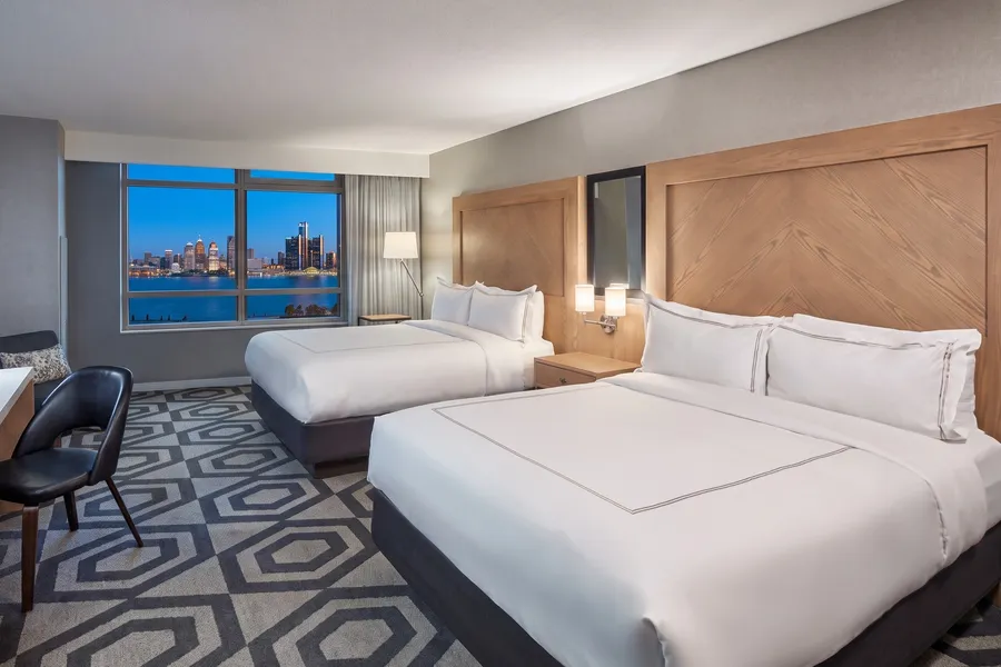 Hotel room with two beds over the river at dusk